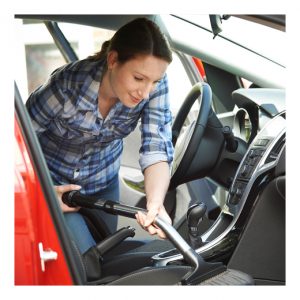 woman vacuuming car